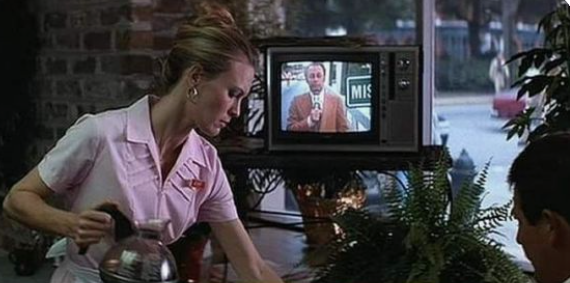 Film still of Jenny working as a waitress at the diner and watching Forrest on television