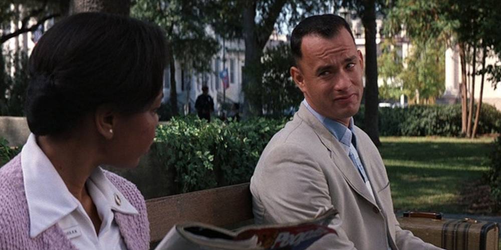 Film still of Forrest talking with a woman on the bench at Chippewa Square in Forrest Gump