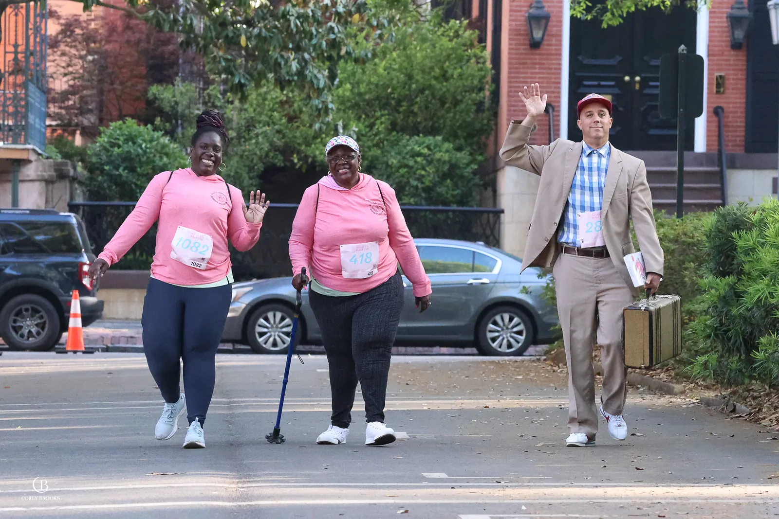 Two race participants posing with the Get Gumped performer