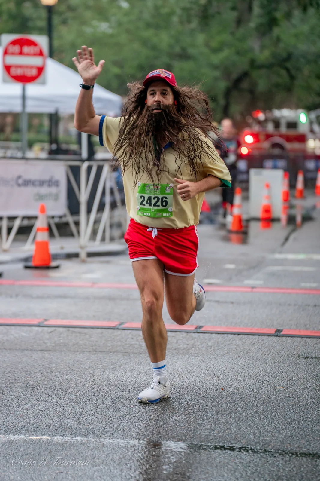 Runner passing the Get Gumped performer at a road race
