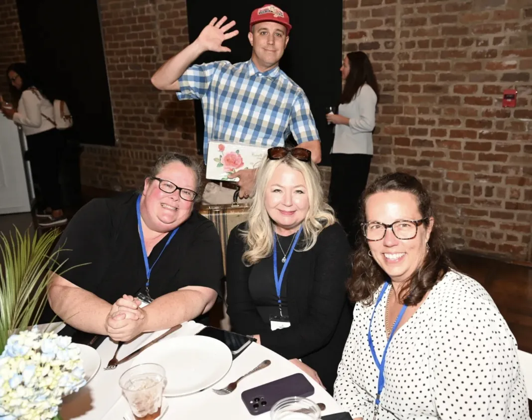 Dinner guests posing with the Get Gumped performer